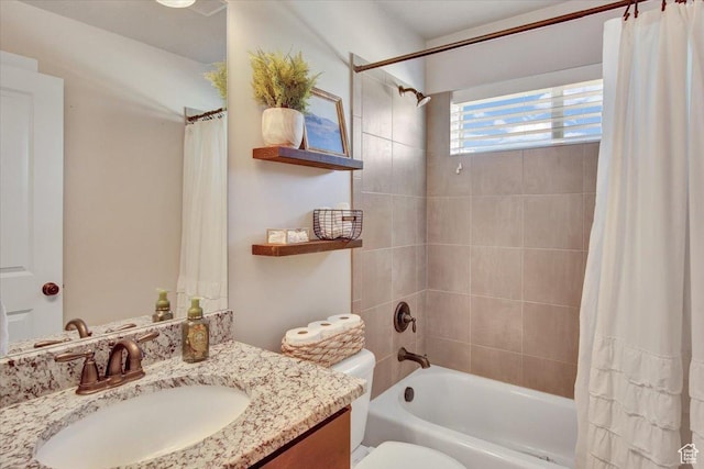 bathroom with shower / bath combo, vanity, and toilet