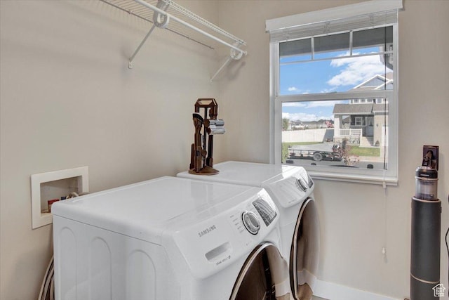 laundry room featuring baseboards, washer and dryer, and laundry area