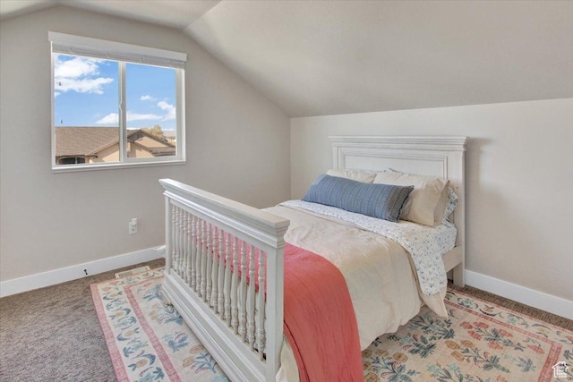 carpeted bedroom with lofted ceiling and baseboards