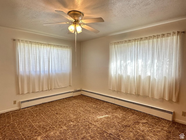 spare room with baseboard heating, a textured ceiling, and ceiling fan