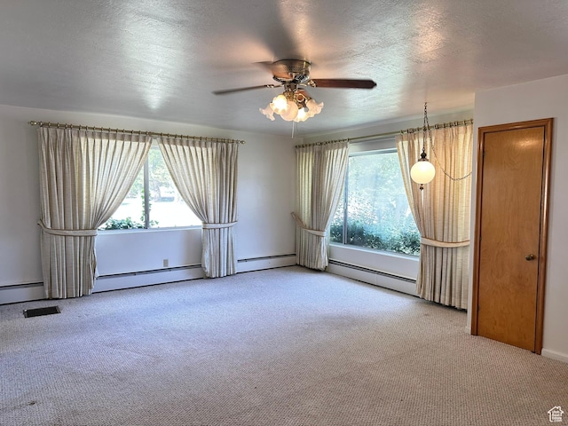carpeted empty room with a ceiling fan, baseboard heating, and a textured ceiling