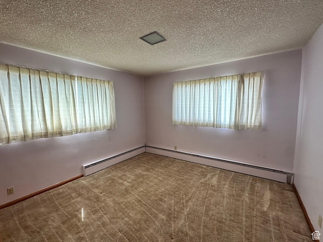 empty room with baseboards, visible vents, carpet floors, and a textured ceiling