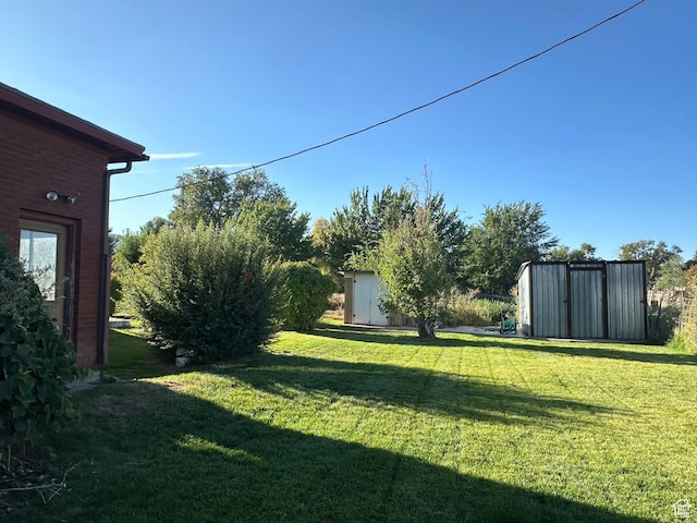 view of yard with a shed and an outbuilding