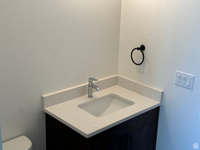 half bathroom featuring toilet and vanity