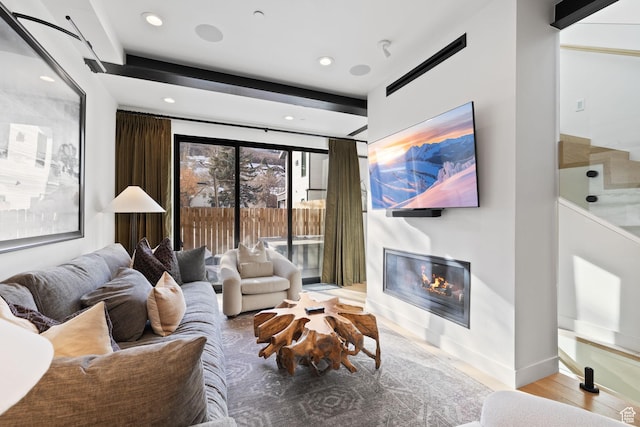 1125 Park Ave Unit 2, Park City, UT 84060 - living room with a glass covered fireplace, recessed lighting, wood finished floors, and baseboards