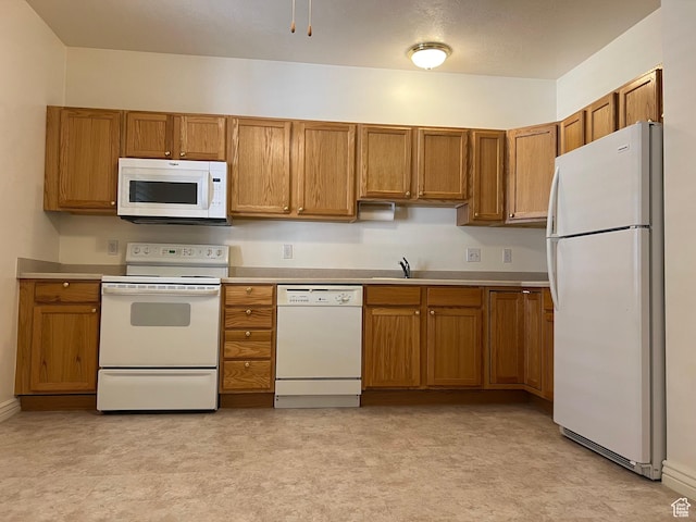 502 S 1040 E Unit 221, American Fork, UT 84003 - kitchen with light countertops, brown cabinetry, and white appliances
