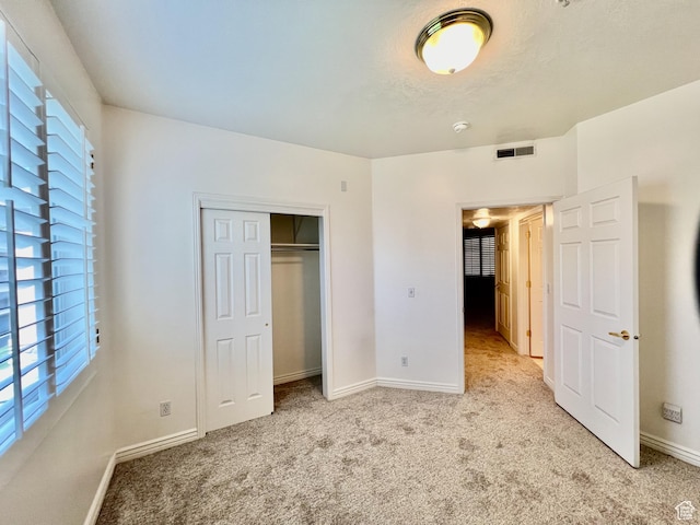502 S 1040 E Unit 221, American Fork, UT 84003 - unfurnished bedroom featuring light carpet, baseboards, a closet, and visible vents