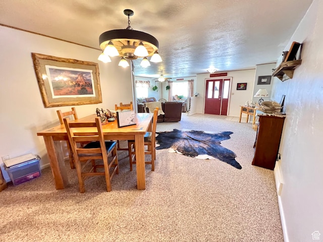 1942 N Sevier Valley Canal Rd, Richfield, UT 84701 - dining area with carpet, a textured ceiling, and an inviting chandelier