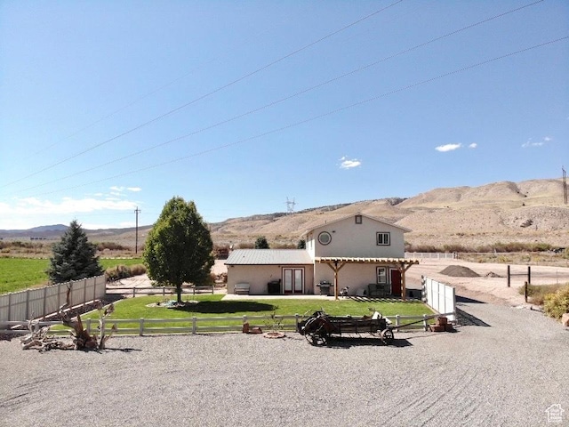 1942 N Sevier Valley Canal Rd, Richfield, UT 84701 - view of front facade with a mountain view, a front yard, fence private yard, and stucco siding
