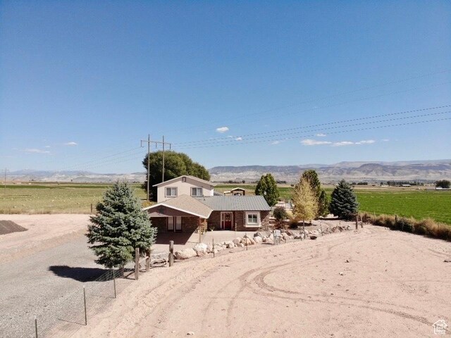 view of front facade featuring a rural view and a mountain view