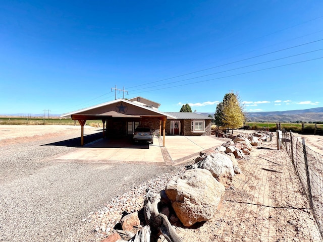 1942 N Sevier Valley Canal Rd, Richfield, UT 84701 - exterior space featuring an attached carport, gravel driveway, metal roof, and fence