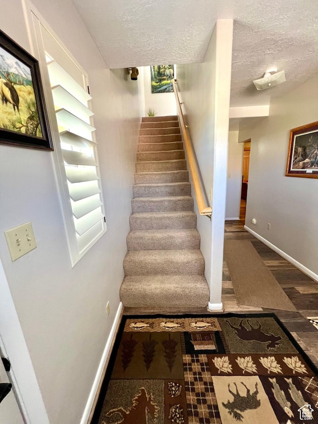 1942 N Sevier Valley Canal Rd, Richfield, UT 84701 - stairs featuring baseboards, wood finished floors, and a textured ceiling