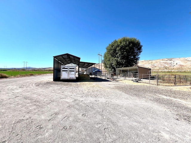 1942 N Sevier Valley Canal Rd, Richfield, UT 84701 - view of yard featuring an exterior structure, a carport, a rural view, and an outbuilding
