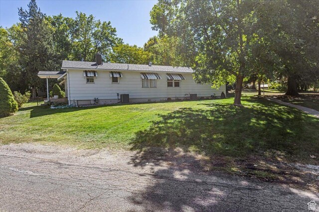 965 E 39th St S, South Ogden, UT 84403 - rear view of property with central AC unit, a lawn, and a chimney