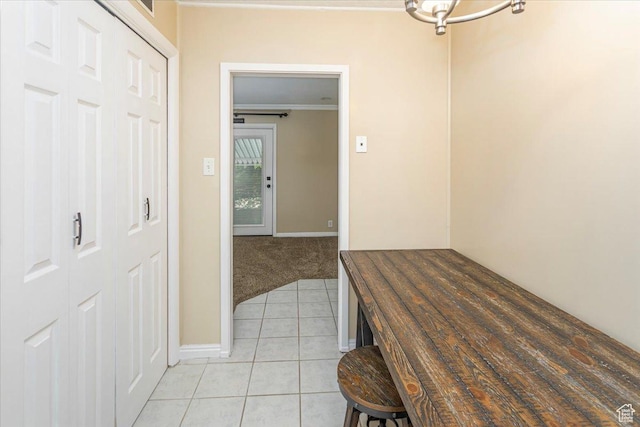 965 E 39th St S, South Ogden, UT 84403 - hallway featuring light tile patterned floors, ornamental molding, baseboards, and light colored carpet