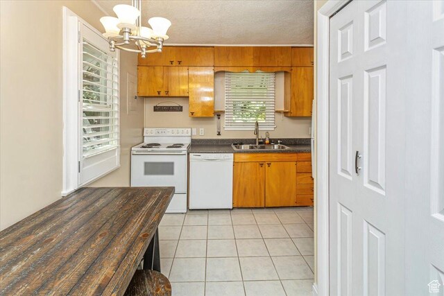 965 E 39th St S, South Ogden, UT 84403 - kitchen with white appliances, a sink, dark countertops, a chandelier, and brown cabinetry