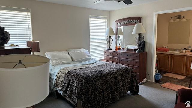 2796 S 2575 W, Roosevelt, UT 84066 - bedroom featuring dark carpet, a sink, connected bathroom, and a ceiling fan