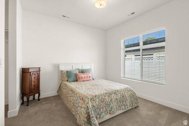 bedroom featuring baseboards, carpet flooring, and visible vents