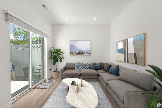 living area featuring light wood-type flooring, recessed lighting, and visible vents