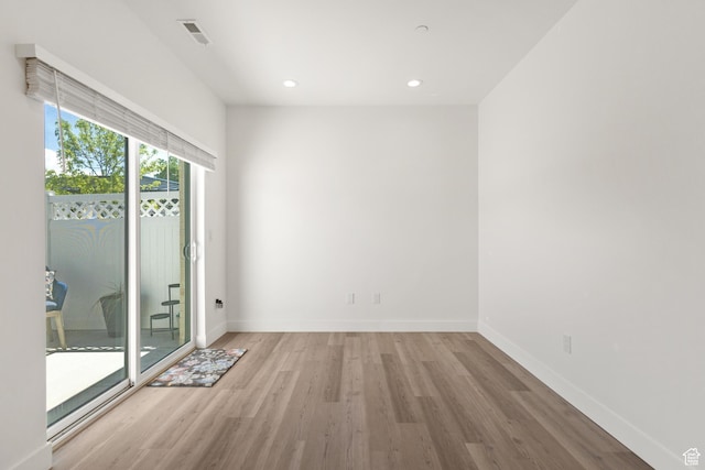 unfurnished room with visible vents, recessed lighting, baseboards, and wood finished floors
