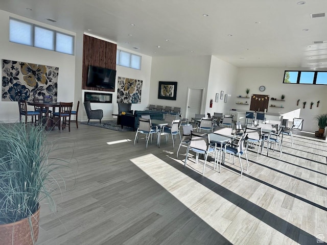 dining room with a healthy amount of sunlight, wood finished floors, and visible vents
