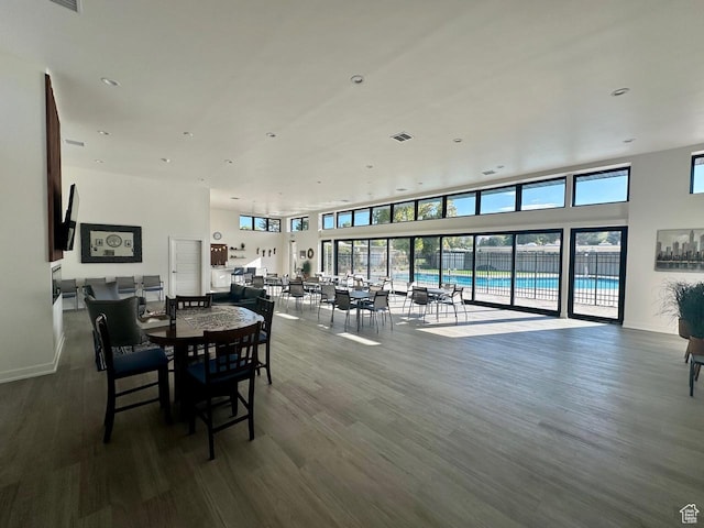dining space featuring visible vents, baseboards, and wood finished floors