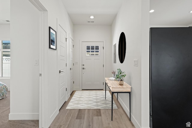 entryway with recessed lighting, baseboards, light wood finished floors, and visible vents