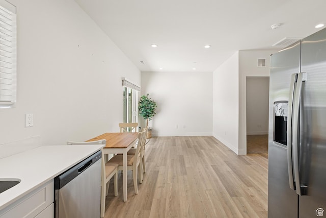 kitchen featuring visible vents, recessed lighting, light countertops, light wood finished floors, and appliances with stainless steel finishes