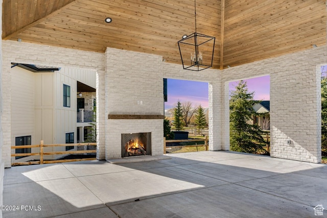 937 Hart Loop, Kamas, UT 84036 - patio terrace at dusk featuring an outdoor brick fireplace