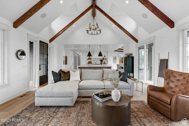 937 Hart Loop, Kamas, UT 84036 - living room with an inviting chandelier, beamed ceiling, hardwood / wood-style floors, and high vaulted ceiling