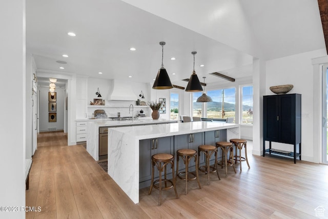 937 Hart Loop, Kamas, UT 84036 - kitchen featuring light hardwood / wood-style floors, white cabinets, custom range hood, decorative light fixtures, and a spacious island