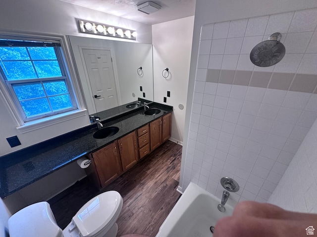 1988 E Gregson Ave, Millcreek, UT 84106 - bathroom with wood finished floors, double vanity, shower / tub combination, and toilet