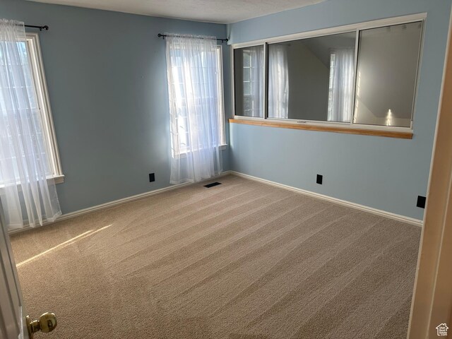 1988 E Gregson Ave, Millcreek, UT 84106 - carpeted empty room featuring baseboards
