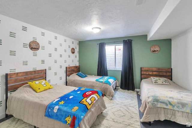 carpeted bedroom featuring a textured ceiling and baseboards