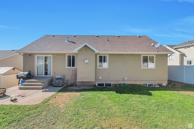 back of house with a patio, stucco siding, central AC unit, fence, and a lawn