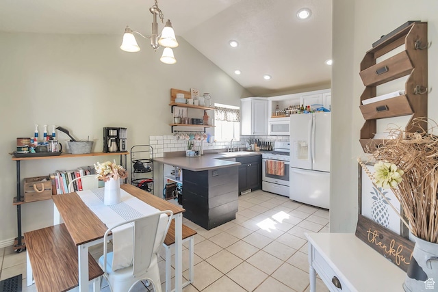 kitchen featuring open shelves, an inviting chandelier, a sink, white appliances, and a peninsula