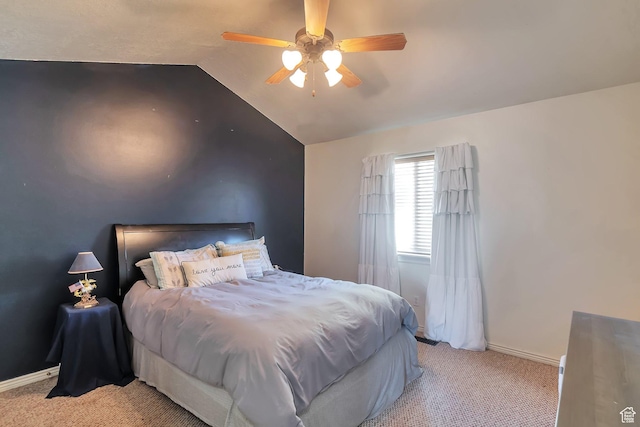 bedroom with baseboards, a ceiling fan, vaulted ceiling, and light carpet
