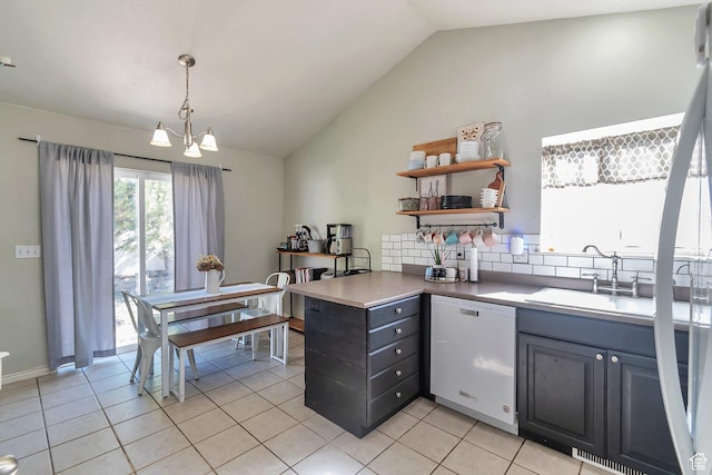 kitchen with open shelves, white dishwasher, a sink, vaulted ceiling, and light tile patterned flooring