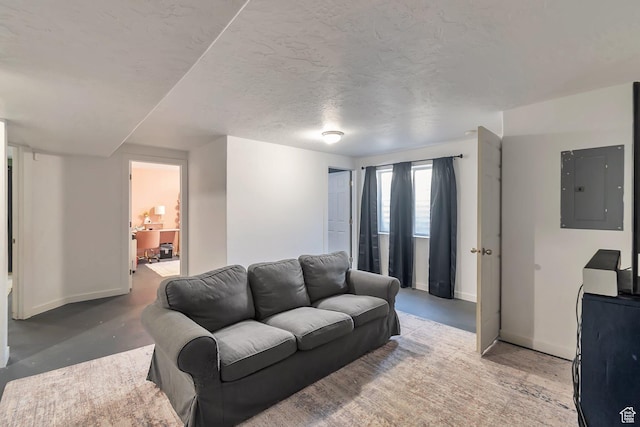 living area featuring electric panel, baseboards, concrete flooring, and a textured ceiling