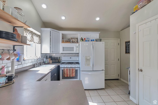 kitchen with light tile patterned floors, open shelves, a sink, white appliances, and white cabinetry