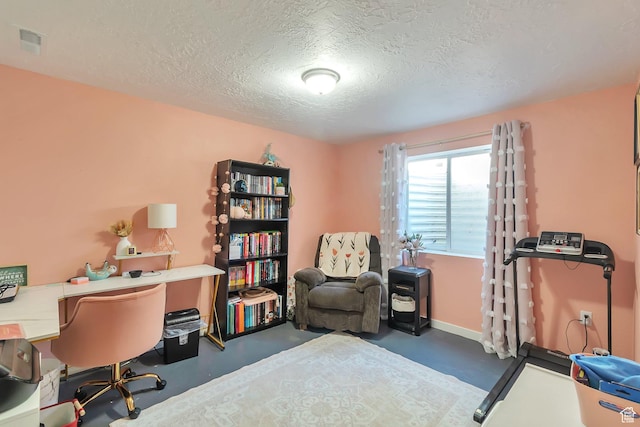 home office with visible vents, baseboards, finished concrete floors, and a textured ceiling