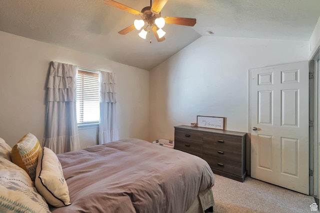 bedroom with light colored carpet, a ceiling fan, and lofted ceiling