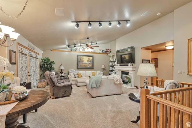 1040 E Canyon Rd, Hyde Park, UT 84318 - living room with lofted ceiling, ceiling fan, carpet floors, and rail lighting