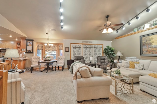 1040 E Canyon Rd, Hyde Park, UT 84318 - carpeted living room featuring ceiling fan with notable chandelier, vaulted ceiling, and track lighting