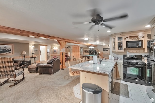 1040 E Canyon Rd, Hyde Park, UT 84318 - kitchen featuring kitchen peninsula, a breakfast bar area, black appliances, ceiling fan, and light carpet