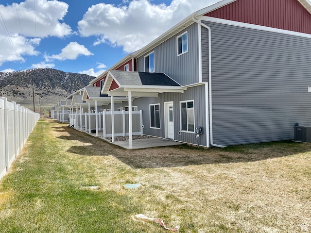 22 E Cedar Ln, Malad City, ID 83252 - back of house with a mountain view, central AC, a patio area, and a yard