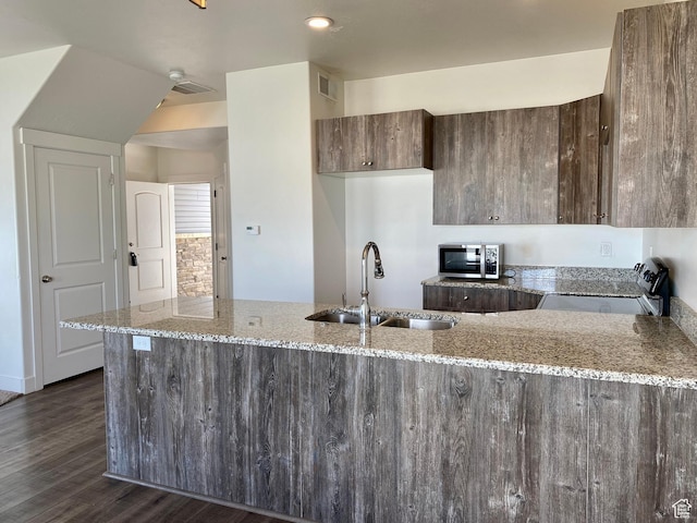 22 E Cedar Ln, Malad City, ID 83252 - kitchen featuring a sink, stainless steel microwave, range with electric stovetop, light stone counters, and a peninsula