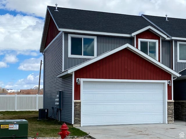 22 E Cedar Ln, Malad City, ID 83252 - view of front of house with stone siding, roof with shingles, and driveway