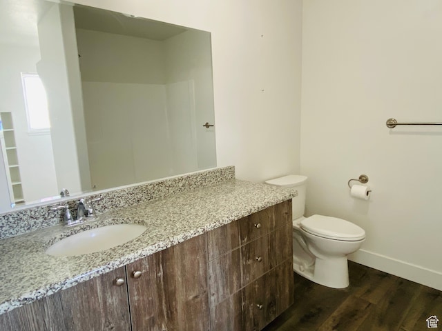 22 E Cedar Ln, Malad City, ID 83252 - bathroom with vanity, toilet, and hardwood / wood-style flooring