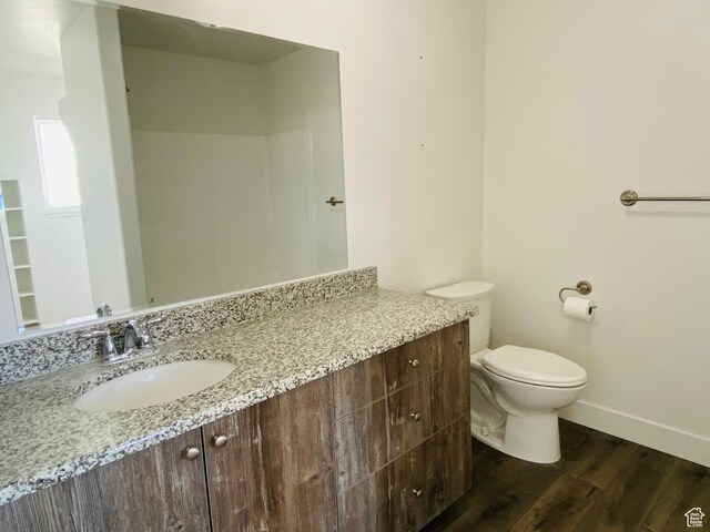 22 E Cedar Ln, Malad City, ID 83252 - bathroom with vanity, wood finished floors, baseboards, and toilet